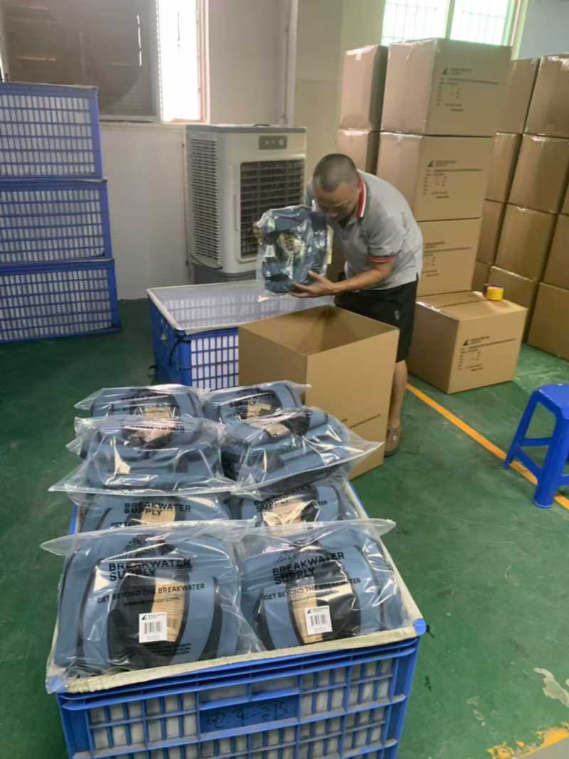 Finished backpacks individually poly-bagged and packed into cartons